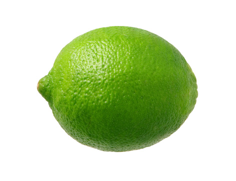  Fresh Green Lime photographed pretty much straight on from a side view.  Lime is a rounded citrus fruit similar to a lemon, but greener, smaller, and with the distinctive acid flavor.  It is grown from an evergreen citrus tree, and is widely cultivated in warm climates.  The subject was photographed with a warm soft box and has highlight in the upper left-hand area.  The lime is a favorite ingredient used by bartenders.  The image is  a cut out, isolated on a white background.