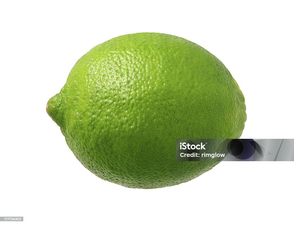 Fresh Green Lime isolated  Fresh Green Lime photographed pretty much straight on from a side view.  Lime is a rounded citrus fruit similar to a lemon, but greener, smaller, and with the distinctive acid flavor.  It is grown from an evergreen citrus tree, and is widely cultivated in warm climates.  The subject was photographed with a warm soft box and has highlight in the upper left-hand area.  The lime is a favorite ingredient used by bartenders.  The image is  a cut out, isolated on a white background. Lime Stock Photo