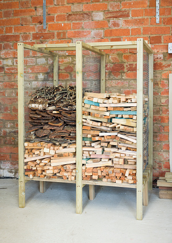 Wooden rack for storing kindling, kindling storage inside a garage, UK
