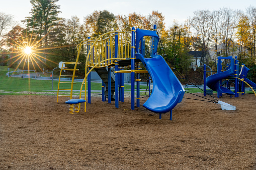 Unidentified typical elementary school playground with engineered wood fiber safety fall surface