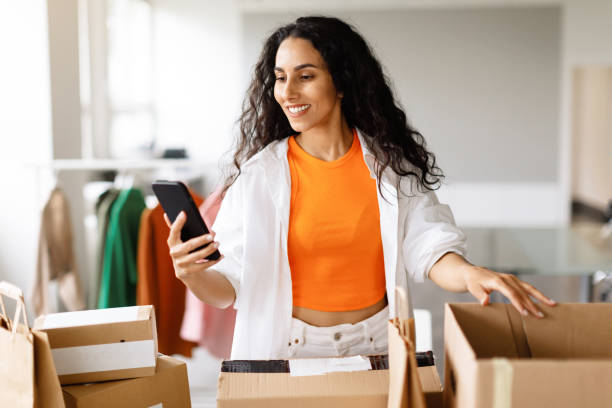 istock Woman Using Smartphone Packing Boxes, Managing Clothing Orders At Showroom 1777264918