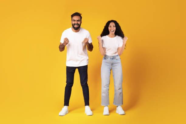 istock Joyful Arabic Spouses Shouting Shaking Fists Standing Over Yellow Background 1777266671