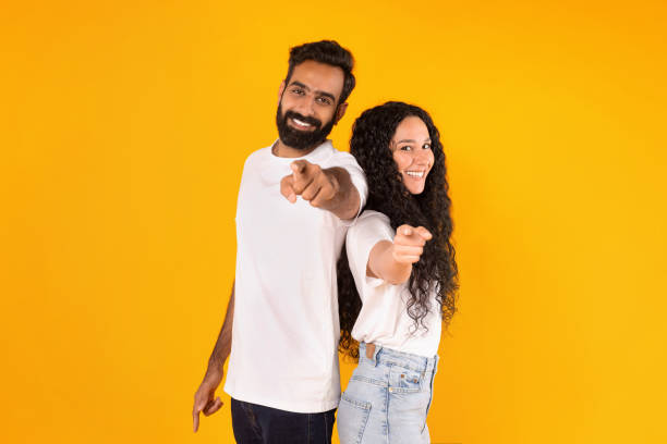 istock Middle eastern man and woman pointing at camera, yellow background 1777267790