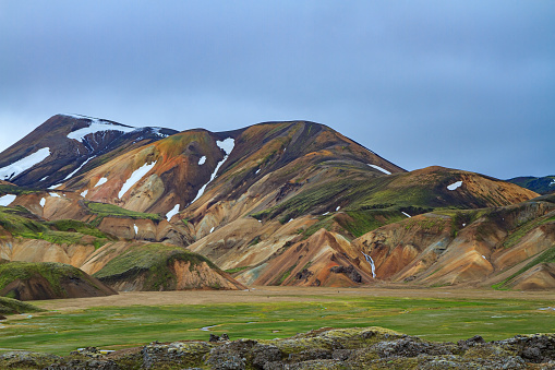 Landmannalaugar. Travel to exotic Iceland. Rhyolite mountains, solidified lava flows and streams changing their courses. Huge swamp overgrown with green grass