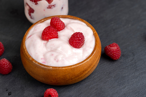 fresh yogurt with raspberry flavor, milk yogurt with raspberry flavor and aroma with red raspberries