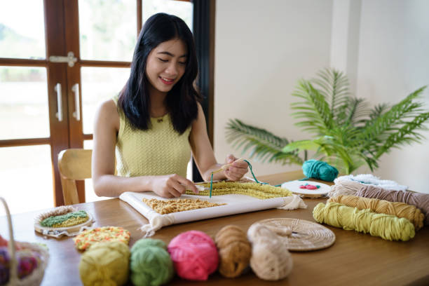 istock Punch needle. Asian Woman making handmade Hobby knitting in studio workshop. designer workplace Handmade craft project DIY embroidery concept. 1777275127