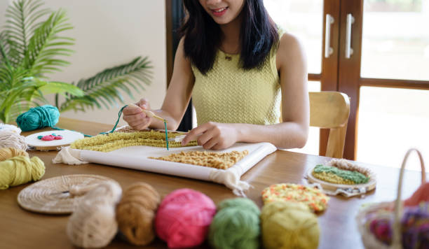 istock Punch needle. Asian Woman making handmade Hobby knitting in studio workshop. designer workplace Handmade craft project DIY embroidery concept. 1777275136