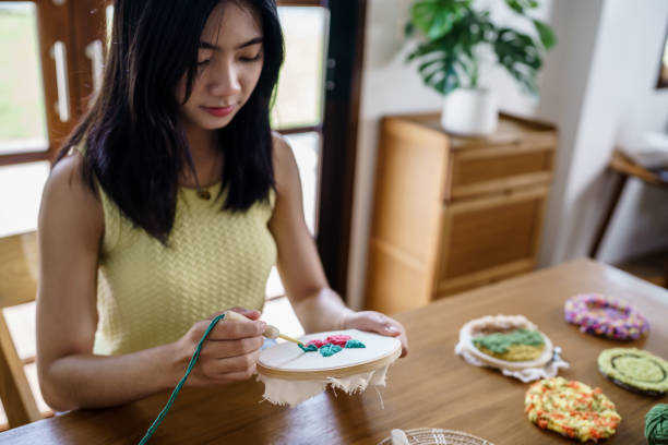 istock Punch needle. Asian Woman making handmade Hobby knitting in studio workshop. designer workplace Handmade craft project DIY embroidery concept. 1777275142