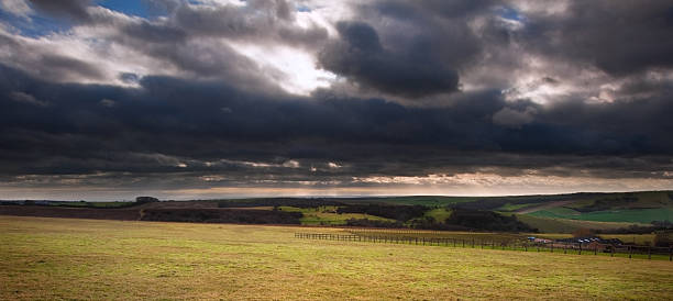 istock Stormy dramatic cloud formations in sky above countryside landscape 177727610