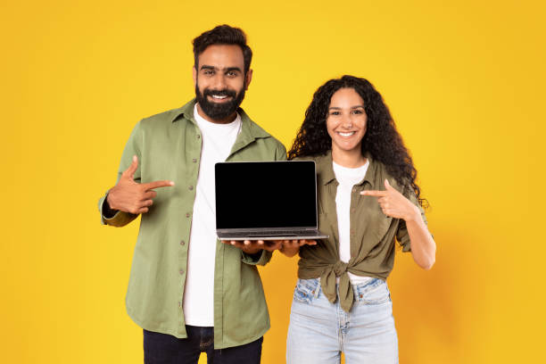 istock Arabic Couple Holding Laptop Pointing At Computer Screen In Studio 1777277441