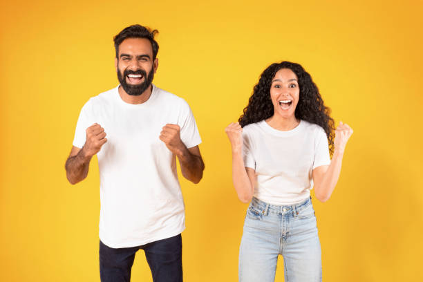 istock Arab Couple Celebrating Success With Yes Gesture On Yellow Background 1777277971