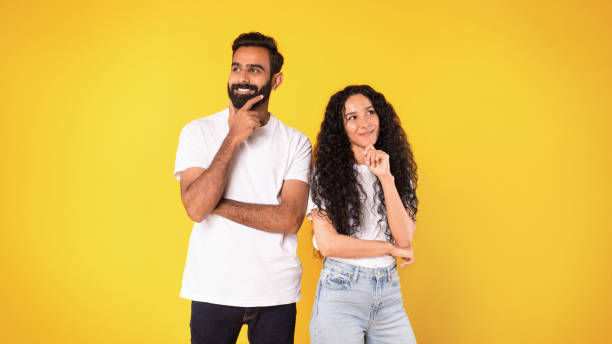 istock Pensive positive middle eastern couple thinking on yellow background 1777277985