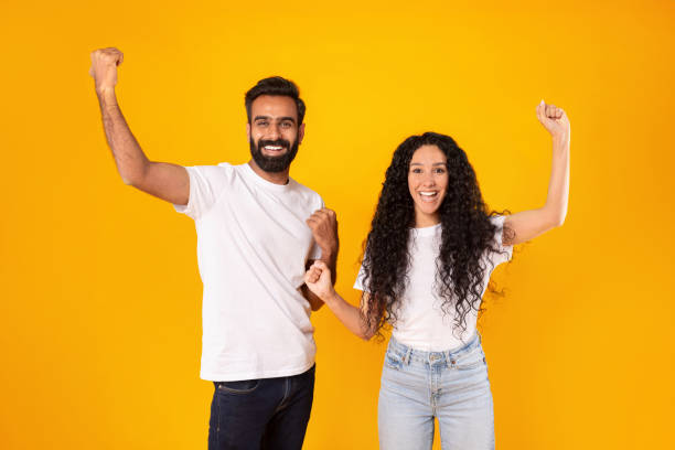 istock Middle Eastern Spouses Shaking Fists With Joyful Expression, Yellow Background 1777278404