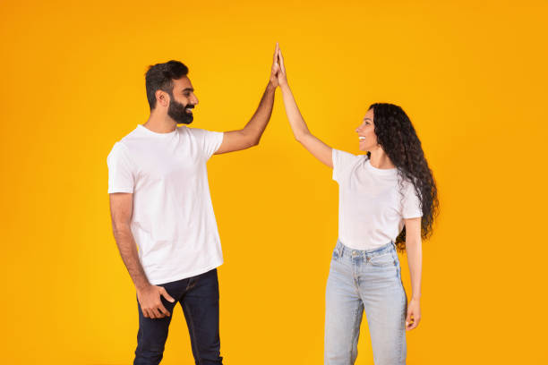 istock Cheerful Arab Young Couple Giving High Five Over Yellow Background 1777278499