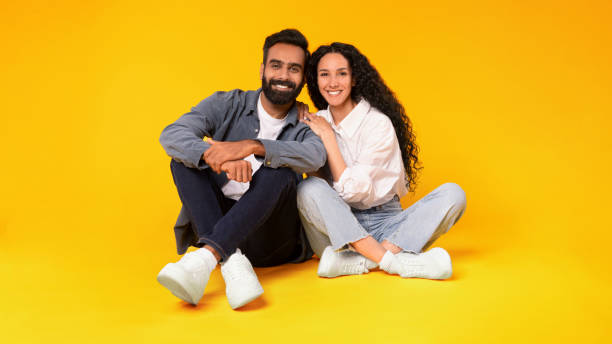 istock Loving Arabic Couple Embracing While Sitting Together Over Yellow Background 1777278515