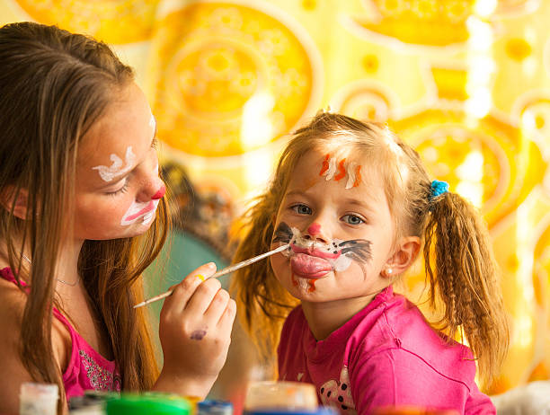 istock Young funny two sisters playing with painting 177727859
