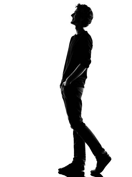 istock young man silhouette walking  happy laughing 177728053