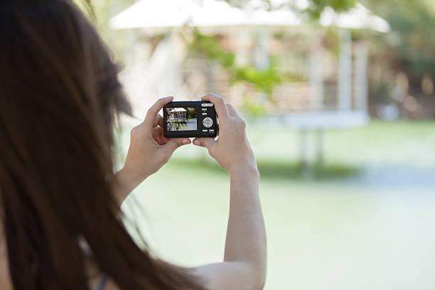 istock Young brunette taking pictures outdoors 177728418