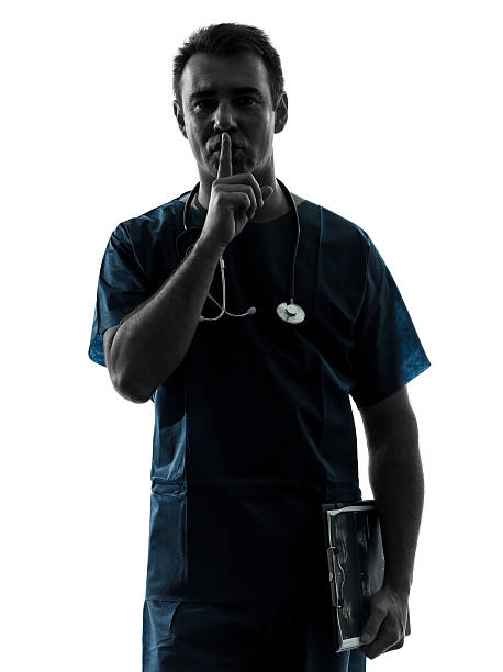 istock doctor man surgeon hushing portrait silhouette 177728450