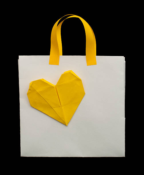istock White shopping bag with yellow heart. 177728984