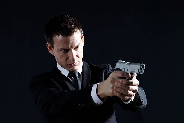 secret agent - bodyguard holding gun 20s stock-fotos und bilder