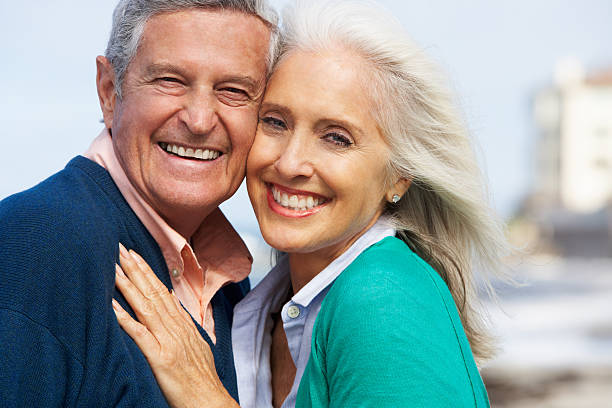 istock A senior couple smiling and hugging outside 177729816