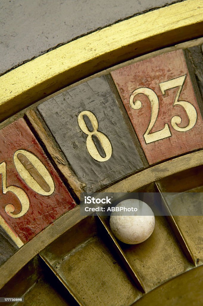 Playing on a vintage roulette Ball on a vintage roulette with numbers Black Color Stock Photo