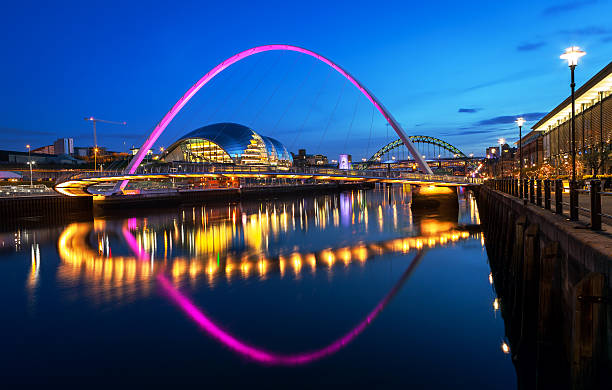 Millennium Bridge Newcastle The Gateshead Millennium Bridge is a pedestrian and cyclist tilt bridge spanning the River Tyne in England between Gateshead's Quays arts quarter on the south bank, and the Quayside of Newcastle upon Tyne on the north bank. image no 190. northeastern england photos stock pictures, royalty-free photos & images
