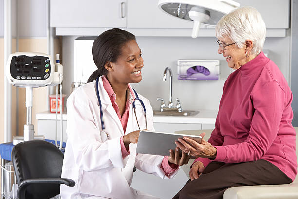 istock A doctor confronts a smiling senior with good news 177732003