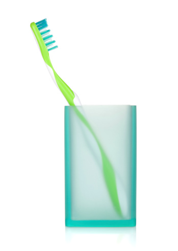 Toothbrush in a glass. Isolated on white background