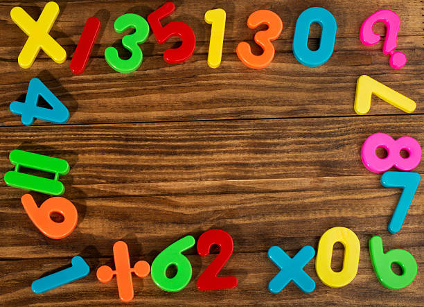 Colorful plastic numbers Colorful plastic numbers on a wooden table number magnet stock pictures, royalty-free photos & images
