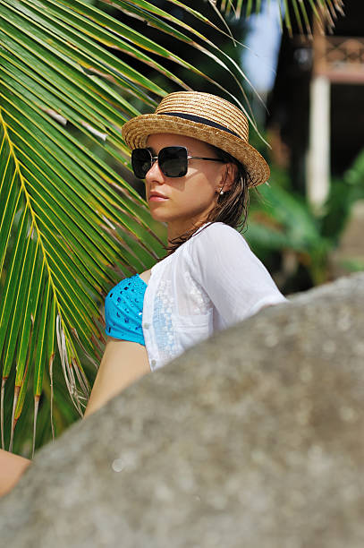 istock Woman in sunglasses near palm tree 177733804
