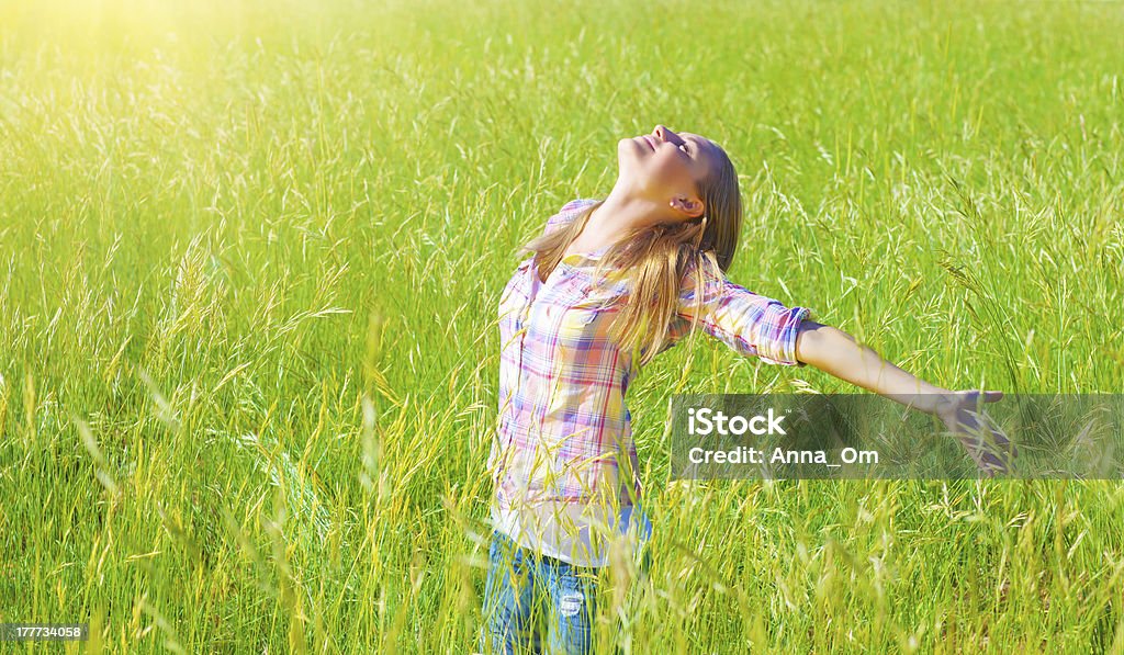 Woman having fun outdoor Woman having fun outdoor, enjoying fresh air and spring green grass, freedom and happiness concept Activity Stock Photo