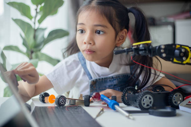 STEM education concept. Asian young girl learning robot design.