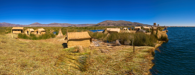 Titicaca lake Peru Uro huts on floating island PANORAMA