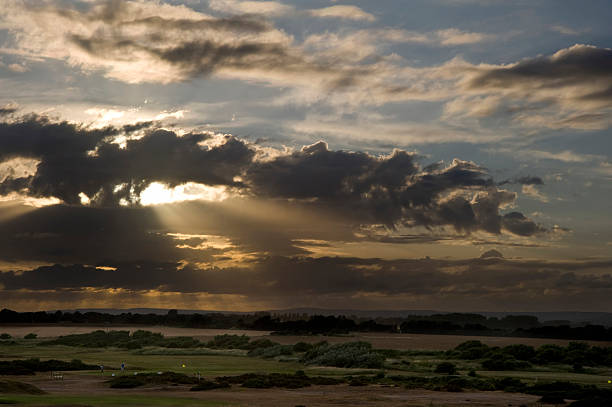 istock Sunset through clouds over links gold course landscape 177737673
