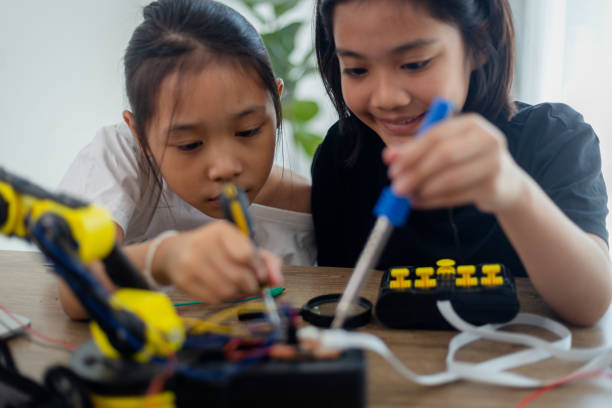 istock nventive kids learn at home by coding robot cars and electronic board cables in STEM. constructing robot cars at home 1777390435