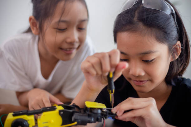 istock nventive kids learn at home by coding robot cars and electronic board cables in STEM. constructing robot cars at home 1777390442