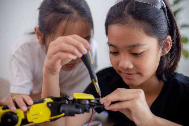 istock nventive kids learn at home by coding robot cars and electronic board cables in STEM. constructing robot cars at home 1777390443