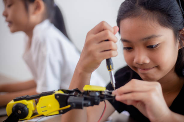 istock nventive kids learn at home by coding robot cars and electronic board cables in STEM. constructing robot cars at home 1777390447