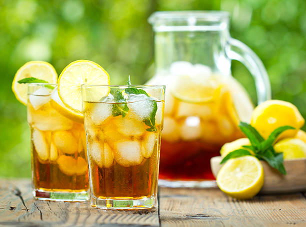 Pitcher and glasses of iced tea with lemons