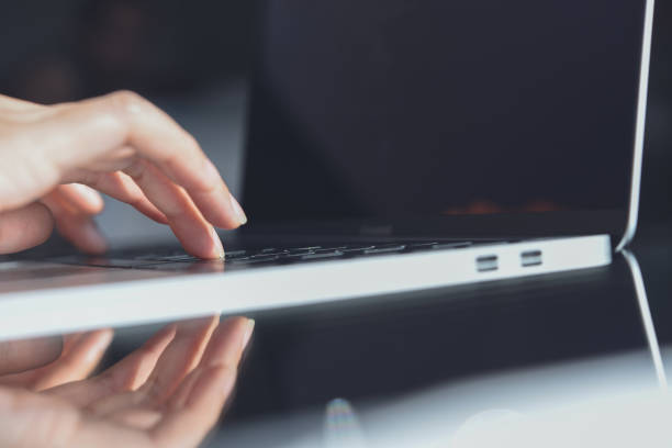 istock Business woman's hands working and typing on laptop computer keyboard on glass table, close up 1777402909