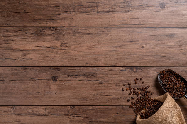 The many coffee beans are placed around on a wooden table