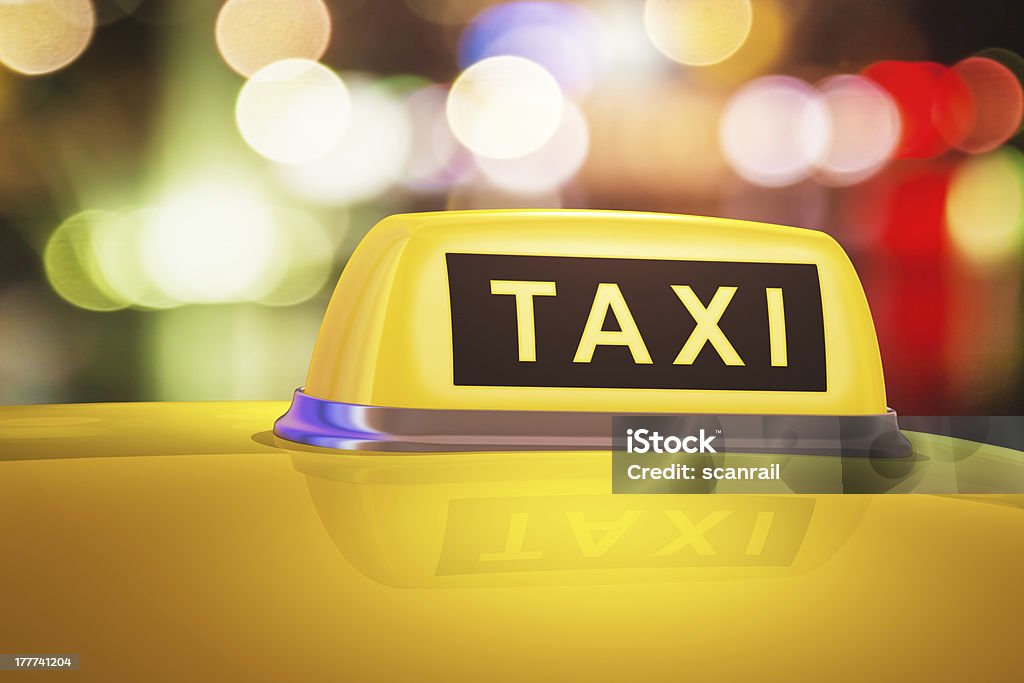 Yellow taxi sign on car Macro view of yellow taxi sign on car in evening or night city street outdoors. See also: Stop - Single Word Stock Photo