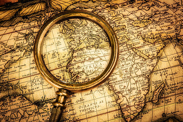 istock Vintage magnifying glass lies on an ancient world map 177744740