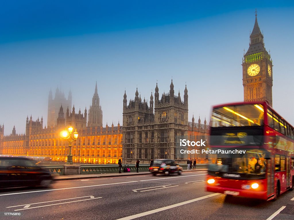 British symbols Houses of Parliament and Big Ben with a red double decker bus and black london taxi in the evening light Architecture Stock Photo