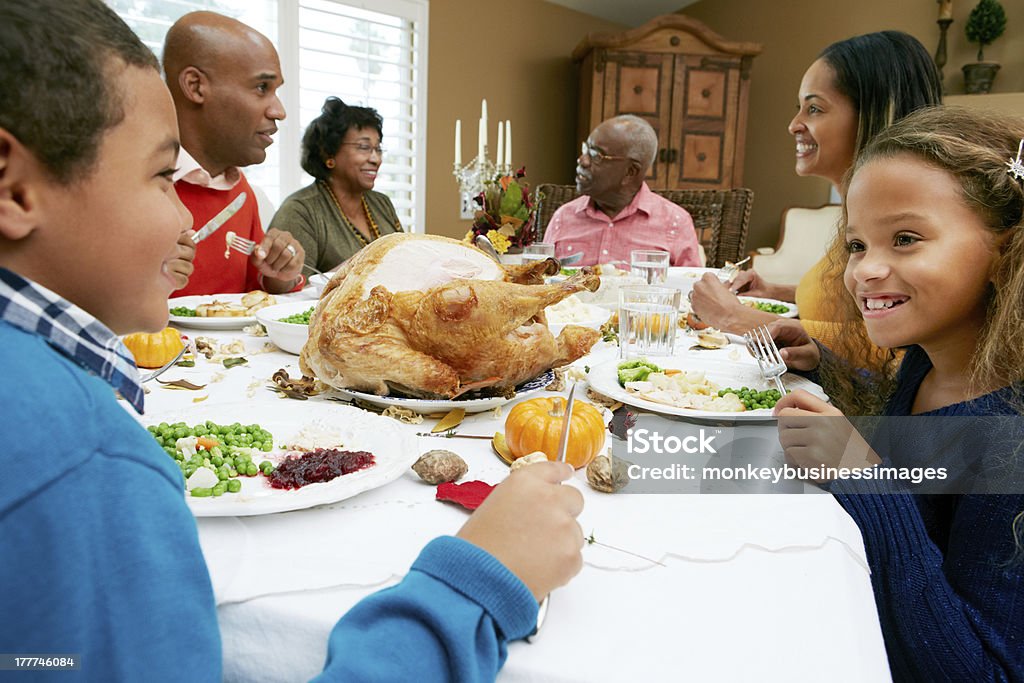 Multi Generation Family Celebrating Thanksgiving Multi Generation Family Celebrating Thanksgiving Eating At Table Chatting Thanksgiving - Holiday Stock Photo