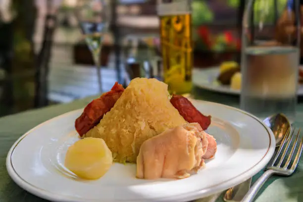 Photo of Alsacian choucroute garnie sauerkraut with sausages and meats Strasbourg, France