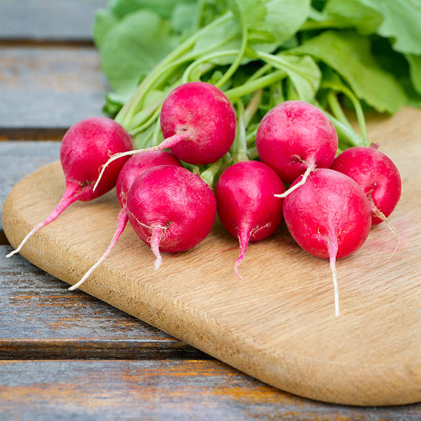 istock Fresh radishes on a wooden cutting board 177747369