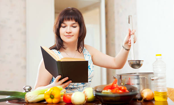 istock housewife cooking with book 177747609